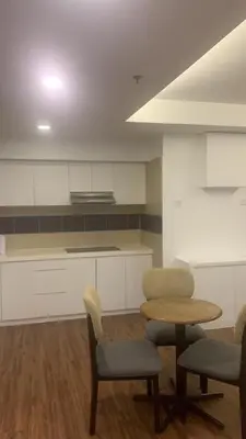 a kitchen with a table and two chairs and a table at RaarFAM Homestay in Kuala Lumpur