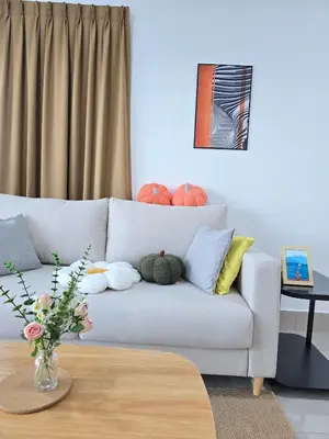 a living room with a couch with pillows and a table at Razak City Kuala Lumpur D4 09 in Kuala Lumpur