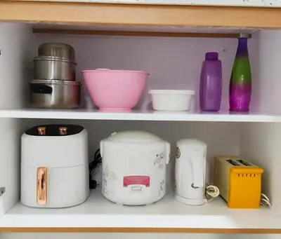 a shelf with various kitchen items on it at Inap KL in Kuala Lumpur