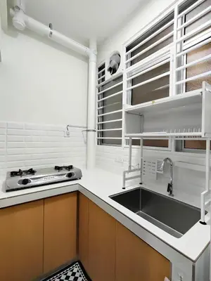 a kitchen with a sink and a stove at Inap KL in Kuala Lumpur