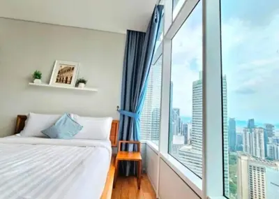 a bedroom with a bed and a large window at Sky Suites Klcc By KD STAR Luxury Suites in Kuala Lumpur