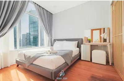 a bedroom with a large bed with a large window at Sky Suites Klcc By KD STAR Luxury Suites in Kuala Lumpur