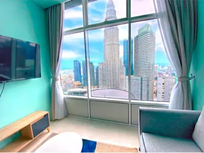 a room with a large window with a view of a city at Sky Suites Klcc By KD STAR Luxury Suites in Kuala Lumpur