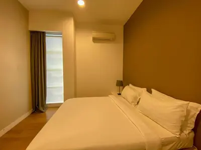 a white bed in a room with a window at Platinum Suites by Kuala Lumpur Malaysia in Kuala Lumpur