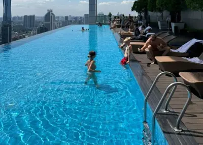 a young child in a swimming pool on top of a building at Platinum Suites by Kuala Lumpur Malaysia in Kuala Lumpur
