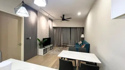 a living room with a table and chairs and a television at One Star KLCC in Kuala Lumpur