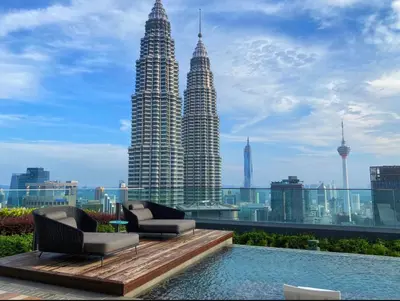 a view of the petronas twin towers from the rooftop of a building at One Star KLCC in Kuala Lumpur