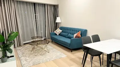 a living room with a blue couch and a table at One Star KLCC in Kuala Lumpur