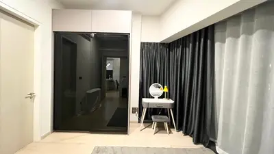 a room with black curtains and a white desk at One Star KLCC in Kuala Lumpur