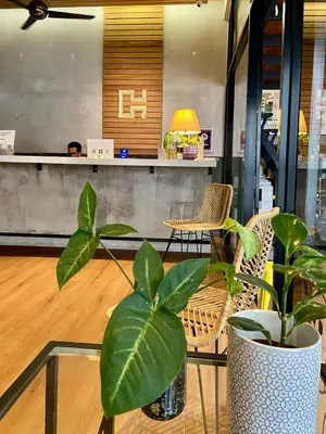 a lobby with chairs and a table with a plant at Chaos Boutique Hotel Kuala Lumpur in Kuala Lumpur