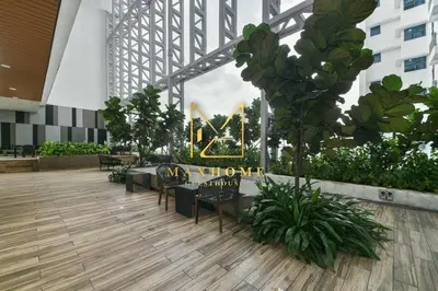 a lobby with chairs and a sign in a building at Maxhome Retreat at The Luxe in Kuala Lumpur
