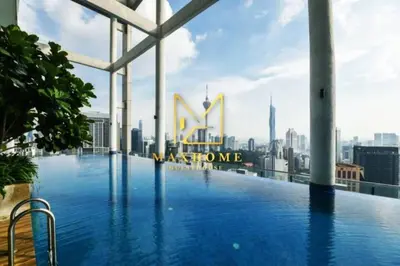 a swimming pool on the roof of a building with a city at Maxhome Retreat at The Luxe in Kuala Lumpur