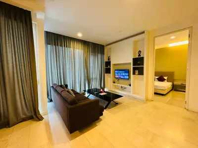a living room with a couch and a television at Platinum Suites KLCC By Premium Hospitality in Kuala Lumpur