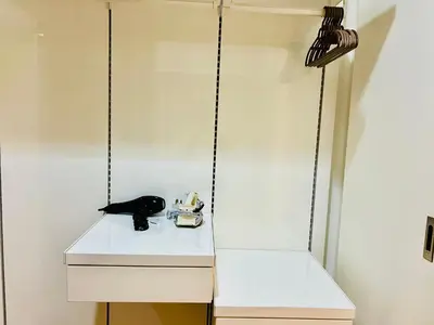 a white closet with a black telephone on a shelf at Platinum Suites KLCC By Premium Hospitality in Kuala Lumpur