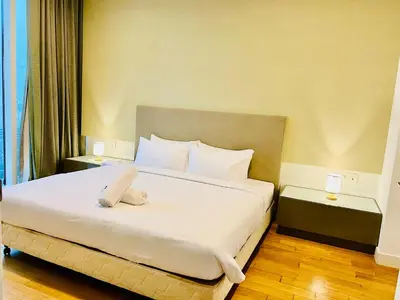 a bedroom with a large bed with white sheets and pillows at Platinum Suites KLCC By Premium Hospitality in Kuala Lumpur