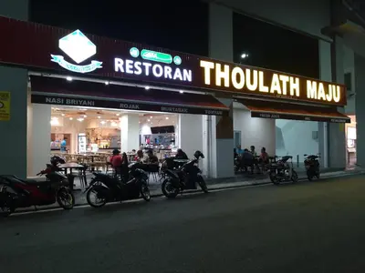 a row of motorcycles parked in front of a restaurant at Anaqi Homestay by Razak City Sg Besi in Kuala Lumpur