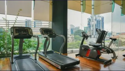 a gym with three exercise bikes and a window at 08-3 Sweet Home-Casa Residency 3R 2B City View in Kuala Lumpur
