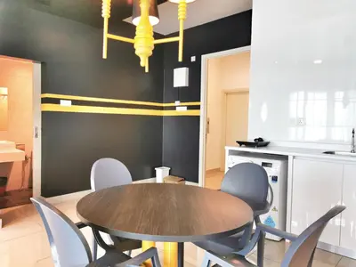 a dining room with a wooden table and chairs at Arte Plus Ampang 2BR Private Lift Suite - Living Signature in Kuala Lumpur
