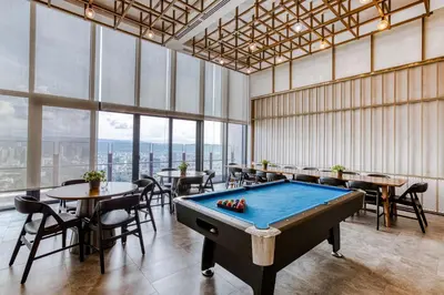 a pool table in a room with tables and chairs at Agile Residence Bukit Bintang, TRX by Isabella in Kuala Lumpur