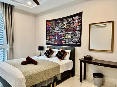 a bedroom with a bed and a picture on the wall at B3A l KLCC TRX Contemporaryl 17 Pax in Kuala Lumpur