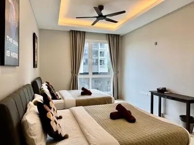 a bedroom with two beds and a ceiling fan at B3A l KLCC TRX Contemporaryl 17 Pax in Kuala Lumpur