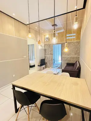 a dining room and living room with a table and chairs at Robertson suites At Bukit Bintang South Lobby in Kuala Lumpur