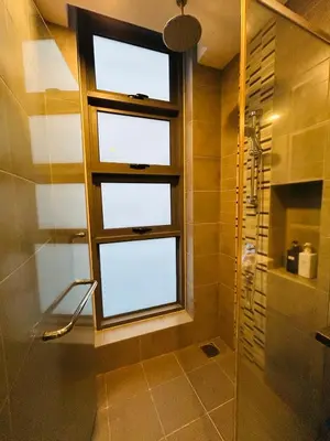 a bathroom with a shower and a window in it at Robertson suites At Bukit Bintang South Lobby in Kuala Lumpur