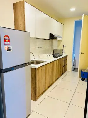 a kitchen with a refrigerator and a sink at Robertson suites At Bukit Bintang South Lobby in Kuala Lumpur