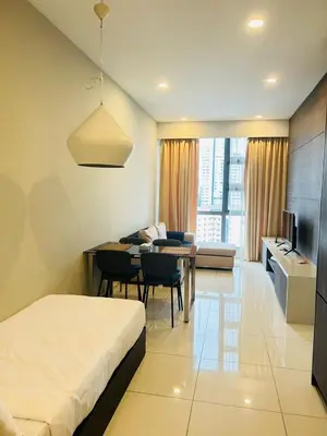 a bedroom with a bed and a living room at Robertson suites At Bukit Bintang South Lobby in Kuala Lumpur