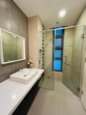 a bathroom with a sink and a glass shower at Robertson suites At Bukit Bintang South Lobby in Kuala Lumpur