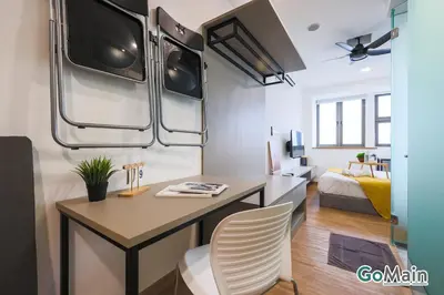 a living room with a desk and a bed at 24H Check in & Skypool - Riveria City Premium KL Suite in Kuala Lumpur