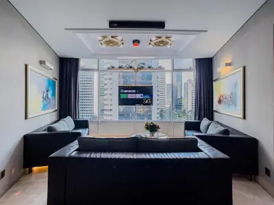 a living room with couches and a large window at Vortex Suites Klcc By VIP SUITES in Kuala Lumpur