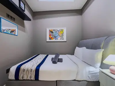 a bedroom with a bed with a remote control on it at Vortex Suites Klcc By VIP SUITES in Kuala Lumpur