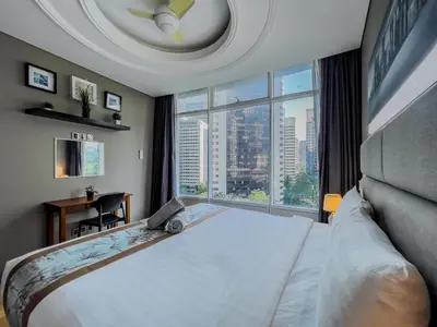 a bedroom with a large bed and a large window at Vortex Suites Klcc By VIP SUITES in Kuala Lumpur