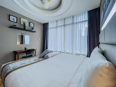 a bedroom with a large bed and a window at Vortex Suites Klcc By VIP SUITES in Kuala Lumpur