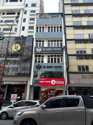 a city street with cars parked in front of buildings at SS Grey Hotel kL in Kuala Lumpur