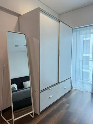 a dressing room with a mirror and a bed at Summer Suite KL City Balcony Room KL Tower View in Kuala Lumpur
