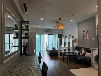 a living room with a couch and a table at Summer Suite KL City Balcony Room KL Tower View in Kuala Lumpur
