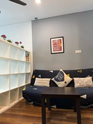 a living room with a couch and a table at Summer Suite KL City Balcony Room KL Tower View in Kuala Lumpur