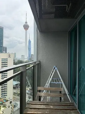 a balcony with a bench and a view of the city at Summer Suite KL City Balcony Room KL Tower View in Kuala Lumpur