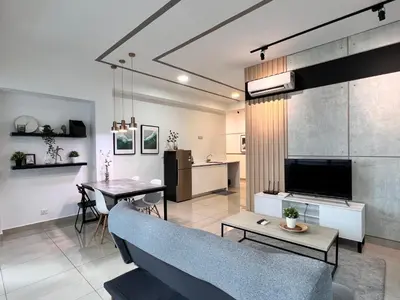 a living room and dining room with a couch and a table at Arte Plus Ampang 2BR Family Suite - Living Signature in Kuala Lumpur