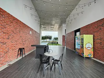 a room with a table and chairs and a brick wall at Lovely Studio room in KL in Kuala Lumpur
