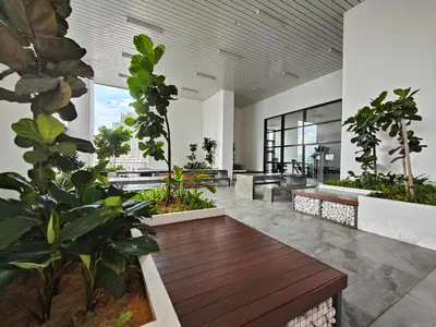 a lobby with benches and plants in a building at Lovely Studio room in KL in Kuala Lumpur