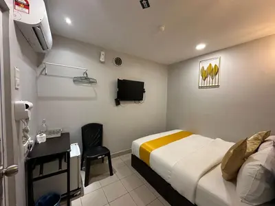 a hotel room with a bed and a tv at SS Grey Hotel BB in Kuala Lumpur