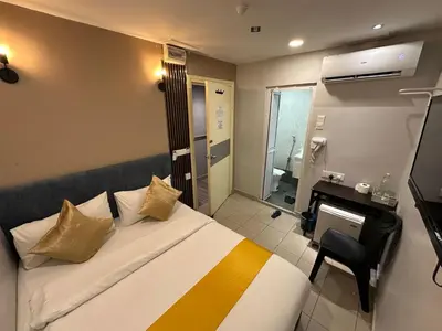a hotel room with a bed and a bathroom at SS Grey Hotel BB in Kuala Lumpur