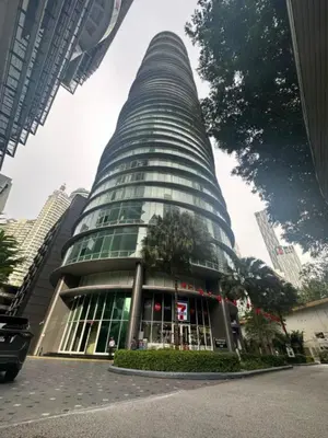 a tall building with a tree in front of it at Vortex Galaxy Suites KL in Kuala Lumpur
