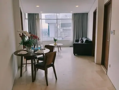 a living room with a table and chairs and a couch at Vortex Galaxy Suites KL in Kuala Lumpur