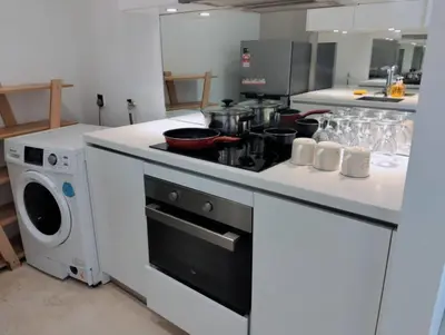 a kitchen with a stove with pots and pans on it at Vortex Galaxy Suites KL in Kuala Lumpur