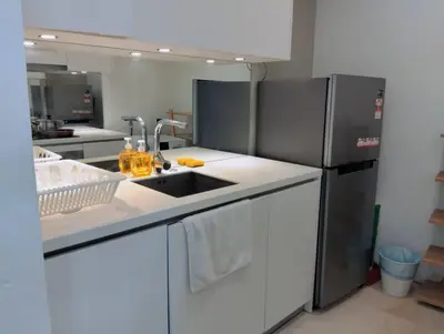 a kitchen with a sink and a refrigerator at Vortex Galaxy Suites KL in Kuala Lumpur