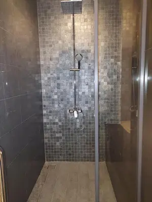 a shower with a glass door in a bathroom at Vortex Galaxy Suites KL in Kuala Lumpur